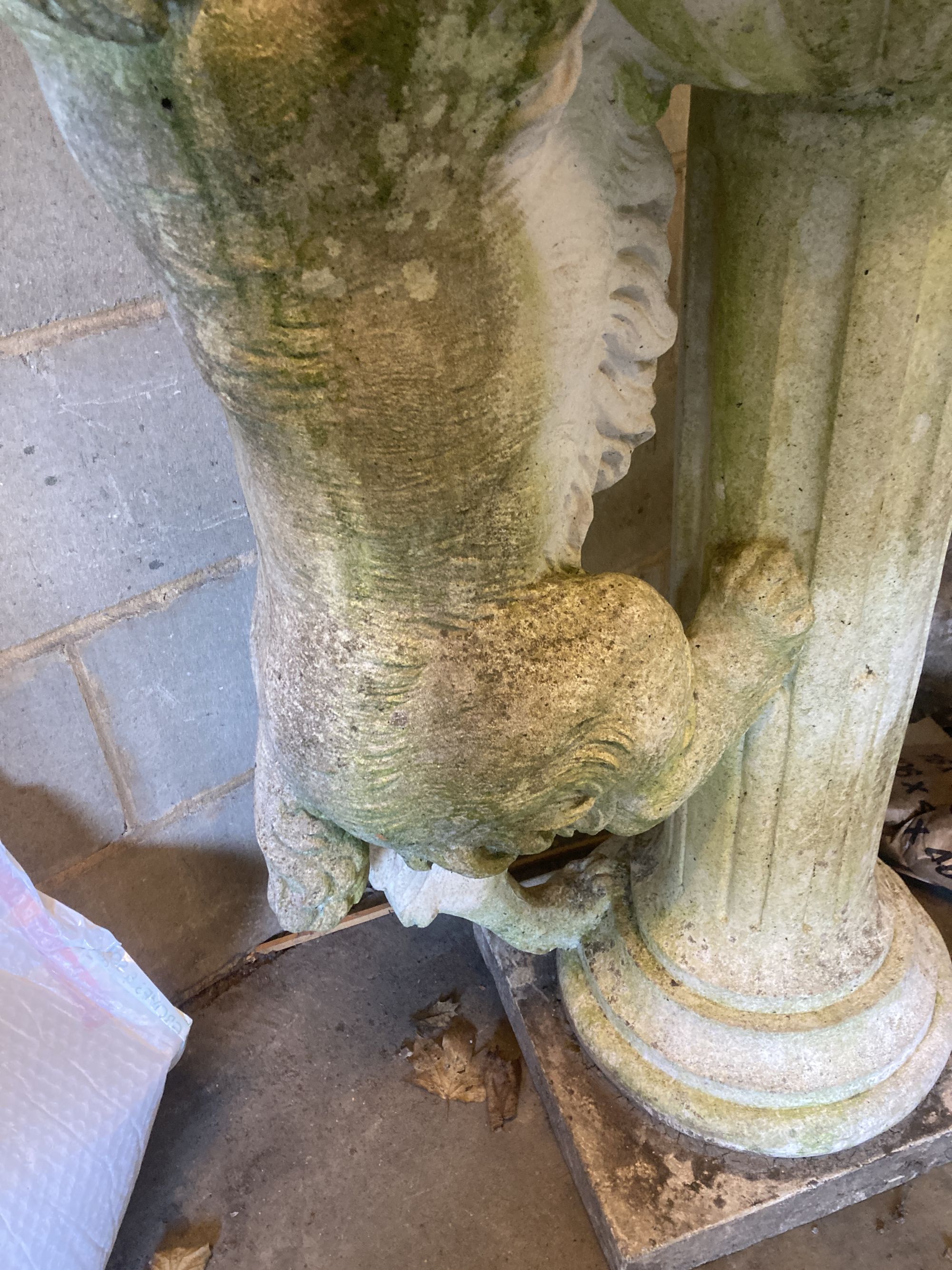 A reconstituted stone garden fountain modelled as a hound drinking from a circular bowl, width 80cm height 112cm